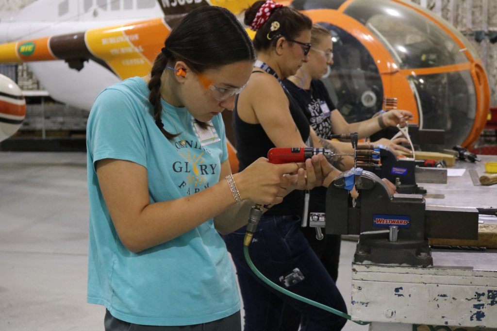 Students practice riveting at Rosie's Girls AVIATION summer camp