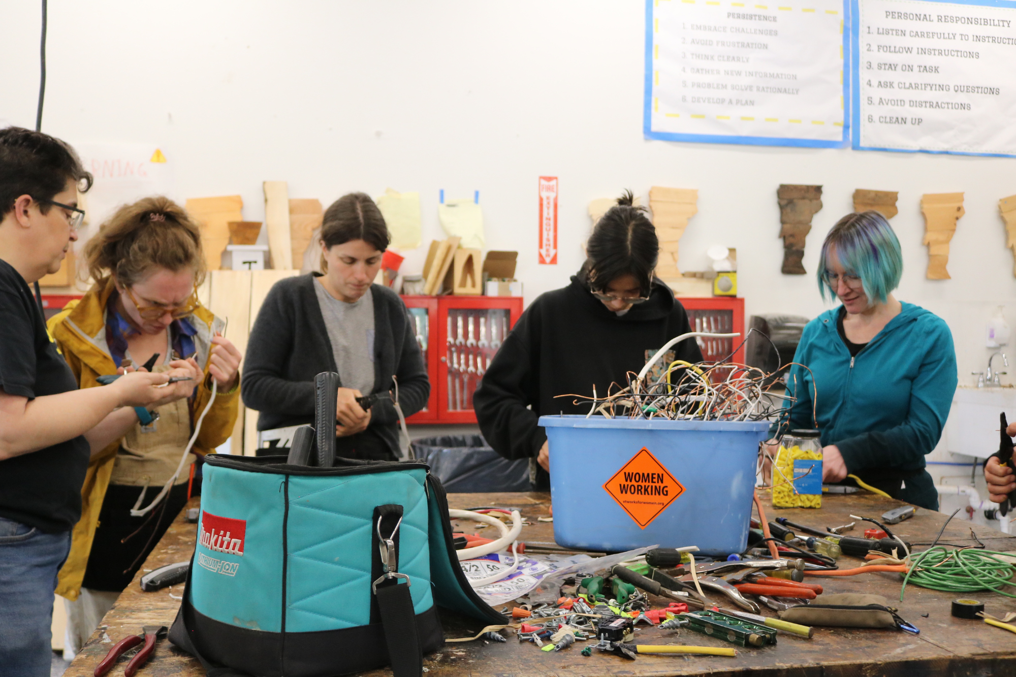 Trailblazers rewire electrical cords during the trades training program