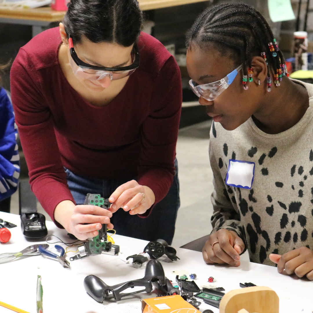 A Rosie's Girls camper explores the inside of electronics at Rosie's Girls TECH.
