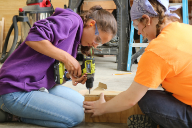 Camper uses power drill at Rosie's Girls camp