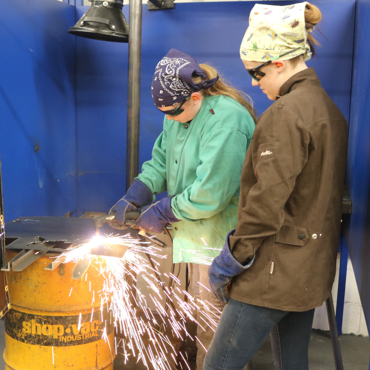 At Rosie's Girls WELD a camper plasma cuts metal with the help of a CIT