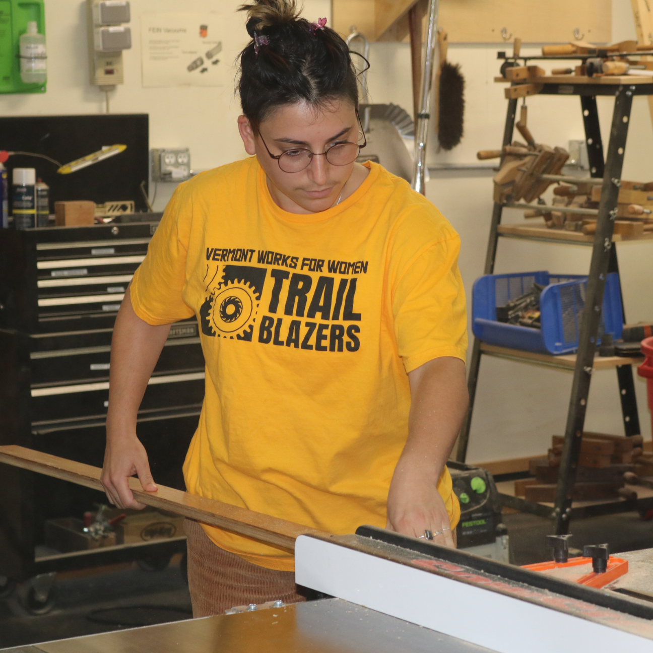 Trailblazers participant uses a table saw to cut wood