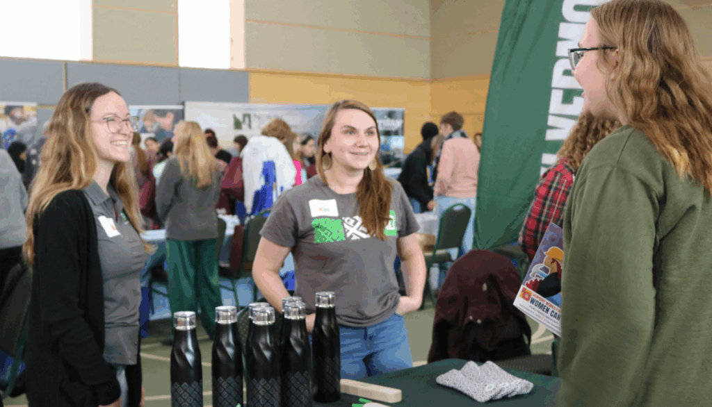 Student talks with TD Bank during the Resource Hall at Women Can Do