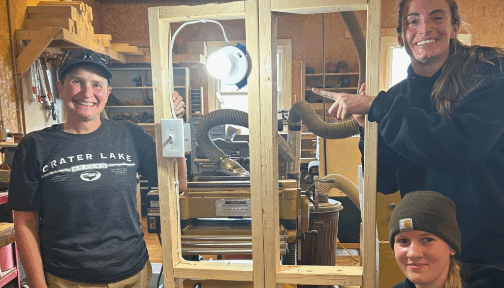 Trailblazers pose with light bulb they successfully wired