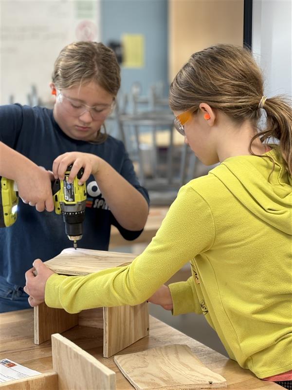 At Rosie's Girls Afterschool in Winooski students use a drill to build a box