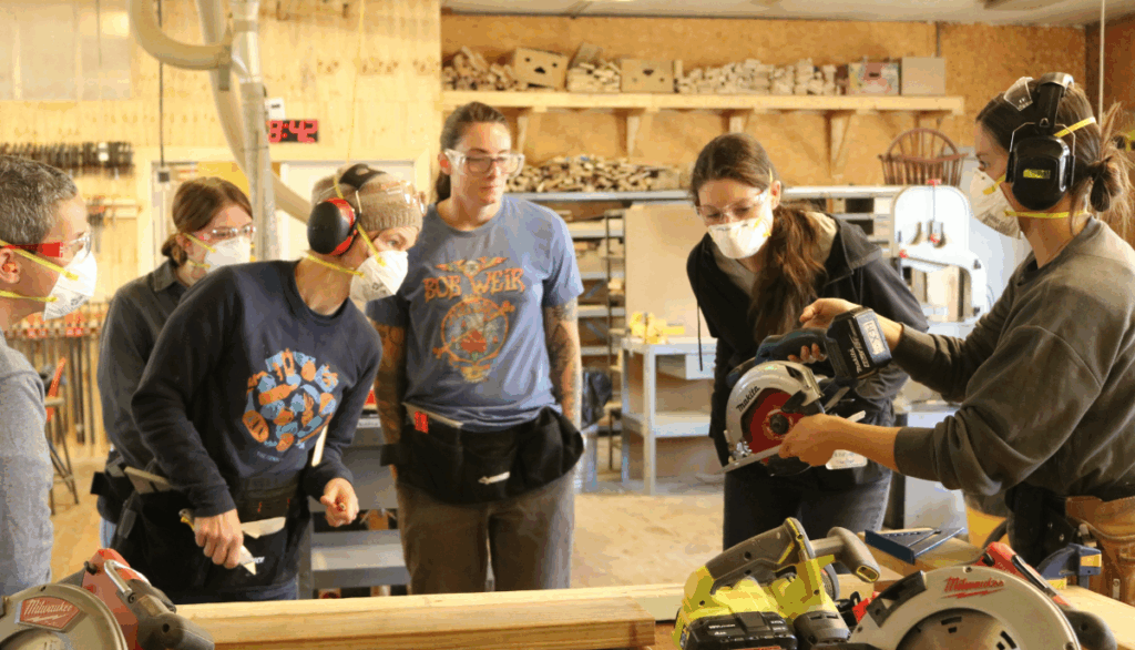 Trailblazers instructor Becky shows the class a circular saw