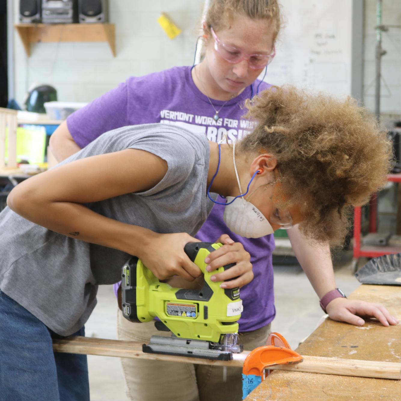 A camper at Rosie's Girls uses a jigsaw at summer camp. Your donation supports programs like this.