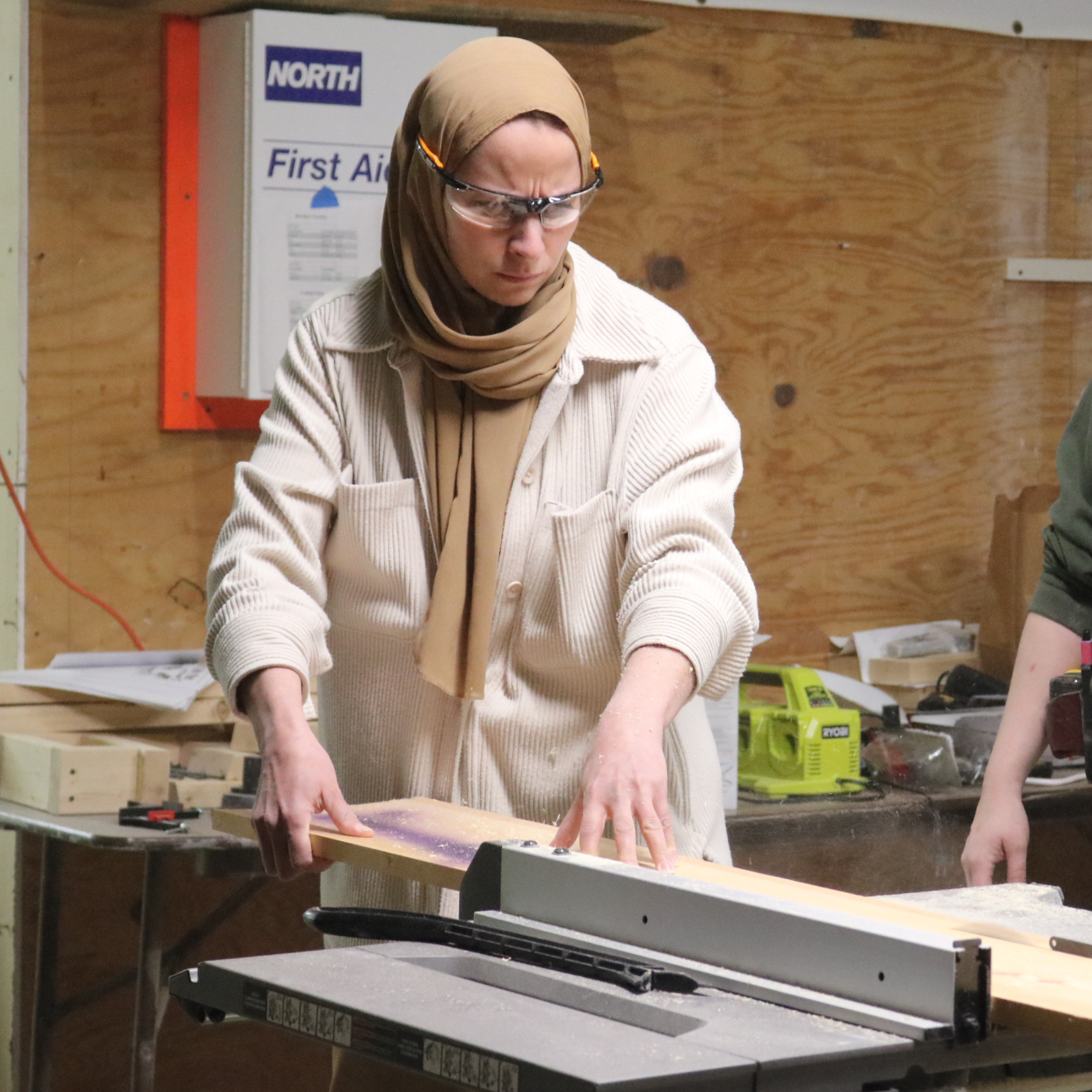 Trailblazer learns to use a table saw during the seven week trades training program