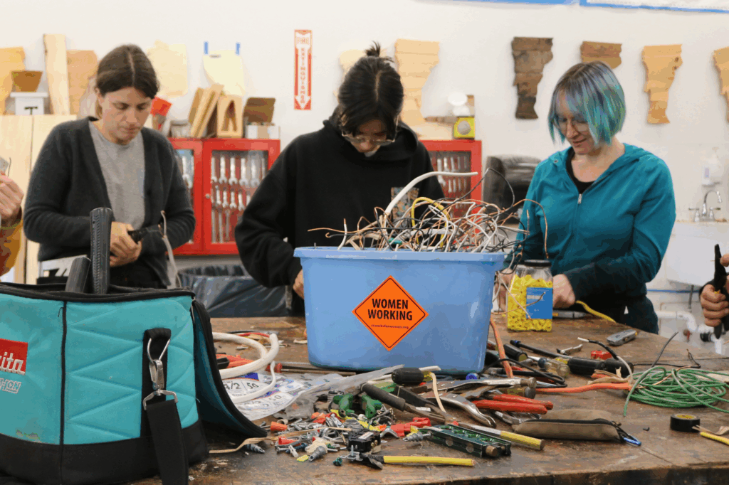 Women work with wires during an electrical lesson at Trailblazers.
