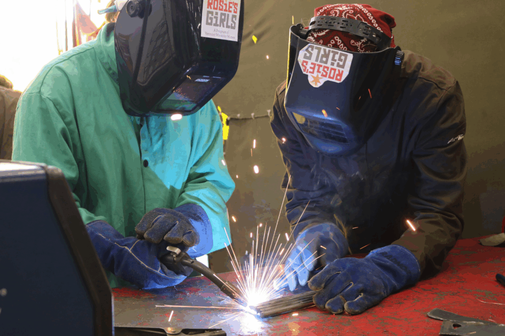 Rosie's Girls WELD campers use a plasma cutter at summer camp.