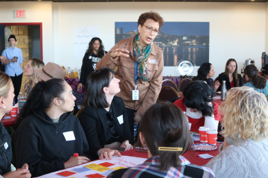Paige Ruffner works with a small group at the Business Through the Looking Glass networking event