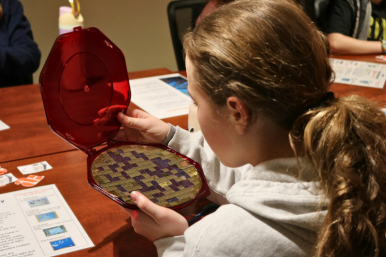 Rosie's Girls TECH camper looks at a GlobalFoundries semiconductor chip