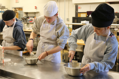 Student whisk cream in culinary arts at Career Challenge Day at RTCC
