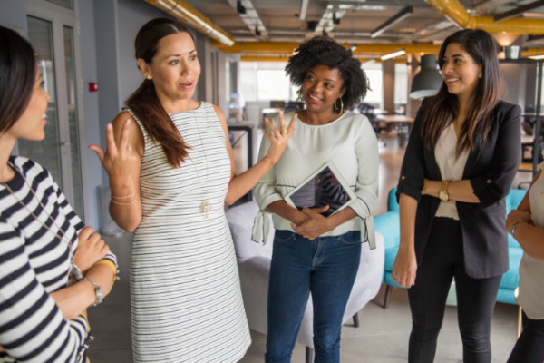 Woman speaks to group of employees