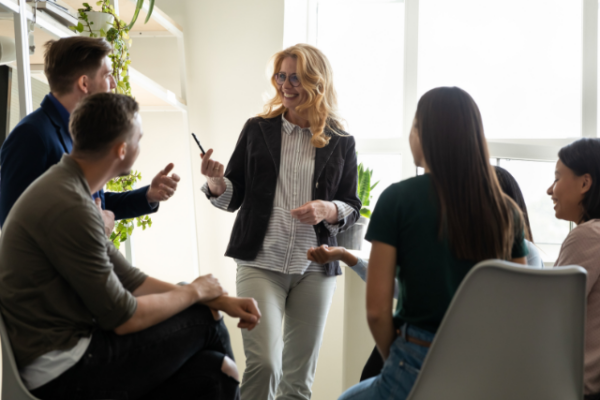 group of coworkers talk at work