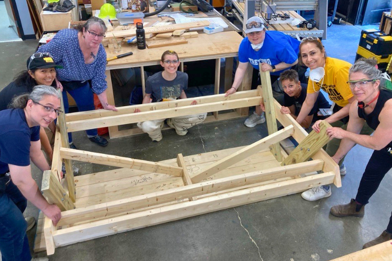 Trailblazers participants pose with the wooden picnic table they built.