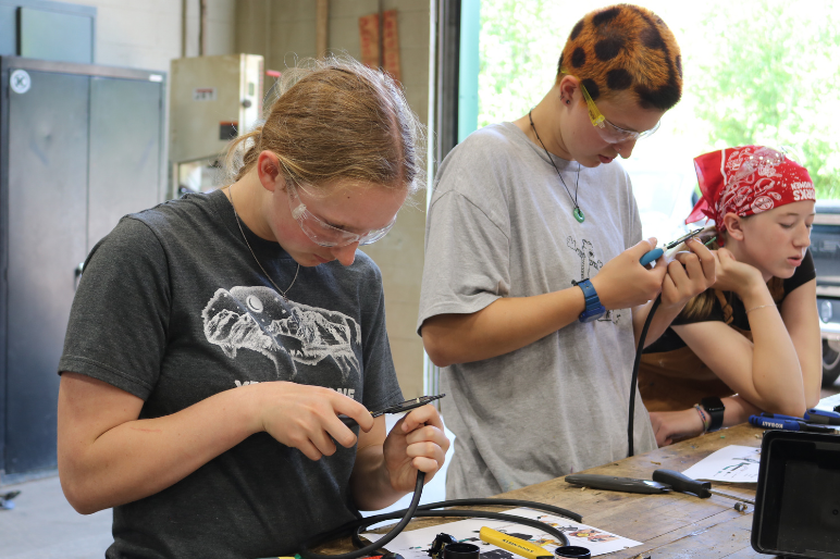 LIFT participants repair power cords during an electrical lesson