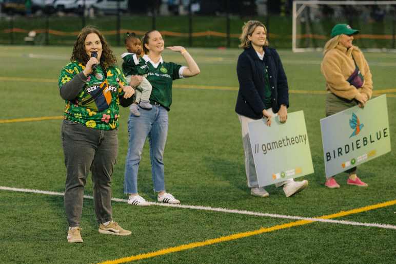 More Green More Good Sponsors stand on field during a halftime presentation