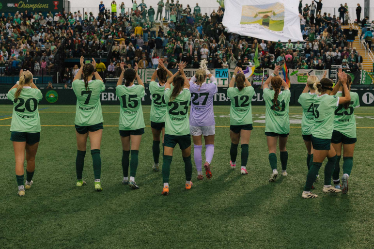 Vermont Green Women's team applauds the crowd after a win