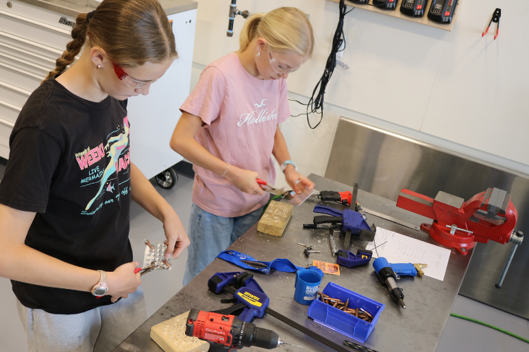 Campers at Rosie's Girls Aviation practice riveting