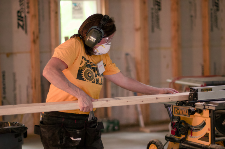 A Trailblazer uses a table saw to cut wood