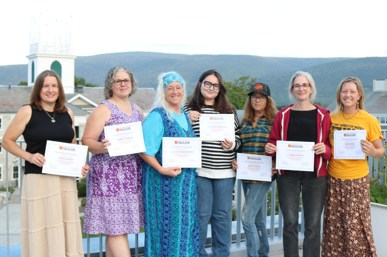 Trailblazers pose together at graduation