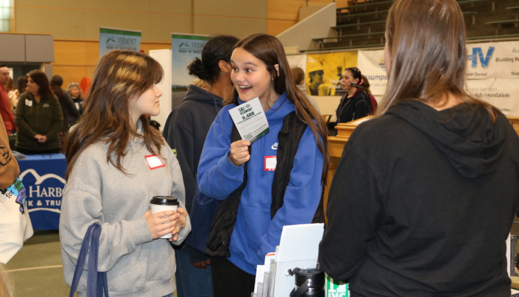 Excited student talking with an exhibitor at Women Can Do